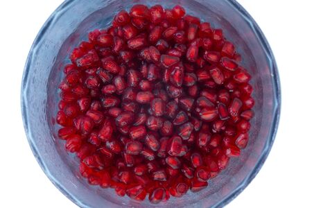 Whole pomegranate with grains on a light background.Whole pomegranate with grains on a light...