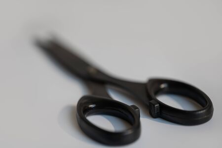 Black scissors lie on a white background.Black scissors lie on a white backgroundの写真素材