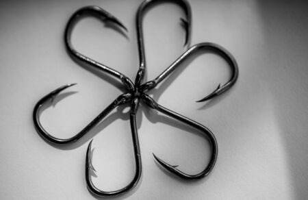 Sharp big fishing hooks on a white background.Sharp big fishing hooks on a white backgroundの写真素材