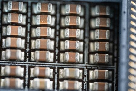 Transistors under the processor socket on the motherboard.Transistors under the processor socket on...