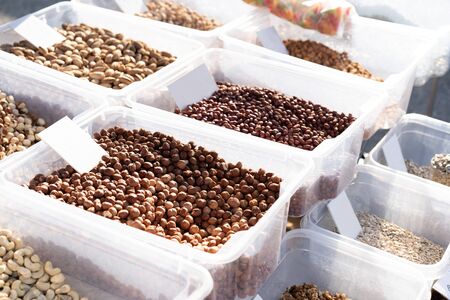 Various nuts on a counter for sale.Various nuts on a counter for sale.