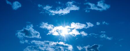 Luminous sun surrounded by cloudsの写真素材