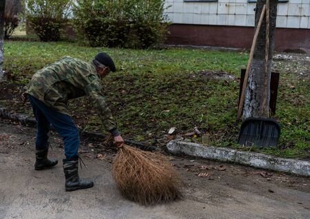 Janitor sweeping a broom yard.Janitor sweeping a broom yardの写真素材