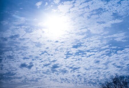 Blue sky with lots of clouds and sunÑBlue sky with lots of clouds and sunの写真素材