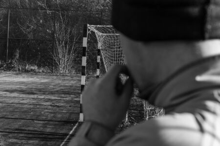 A man on the playground smokesの写真素材