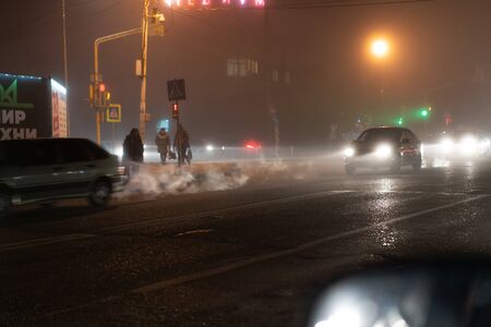 Traffic at an intersection in the fogの写真素材