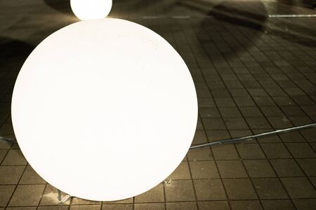 Glowing white huge ball on the earth.の写真素材