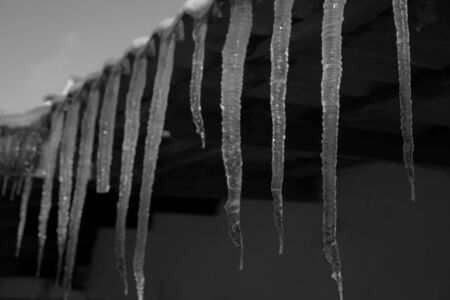 Icicles hanging from the roofの写真素材