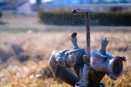 Fire hydrant leaking splashing waterの写真素材
