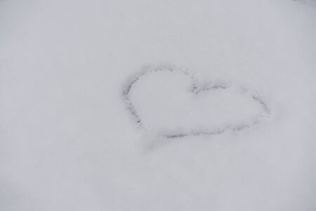 Heart painted on white snowの写真素材