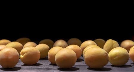 Ripe apricots on a wooden backgroundの写真素材