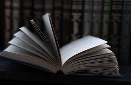 Open book on the background of books