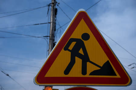 Traffic warning sign about road repair ahead