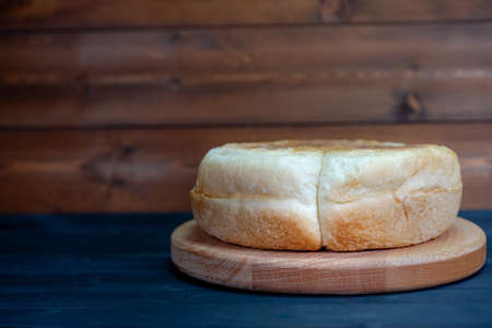 Round bread on a wooden background
