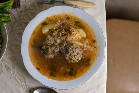 Soup with meatballs, rice, herbs and seasonings