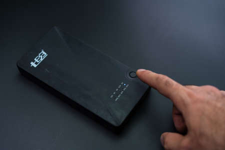 Turning on the charger on a black background