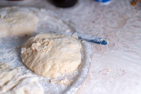 Flour dough sprinkled on a tray