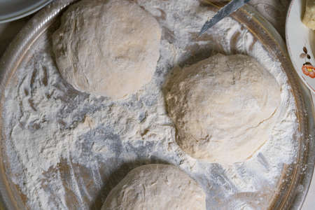 Cooked dough lies on flour for further bakingの写真素材