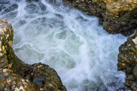 The rapid flow of the river between the rocks