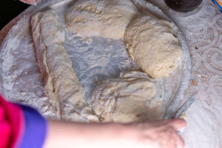 Flour dough sprinkled on a trayの写真素材