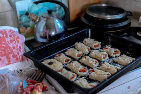 Sweet pastries on a baking sheet from the ovenの写真素材