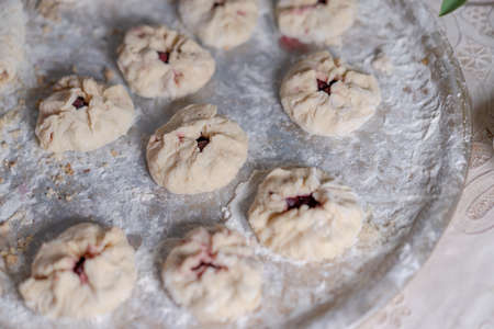 Preparing a pastry for baking buns with jamの写真素材