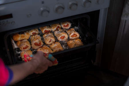 Sweet pastries on a baking sheet from the ovenの写真素材