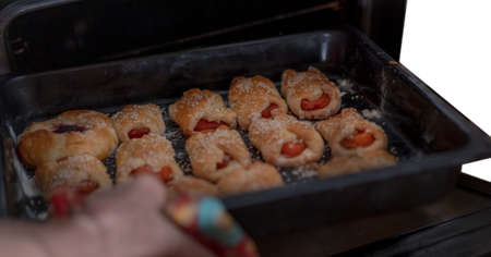 Sweet pastries on a baking sheet from the ovenの写真素材