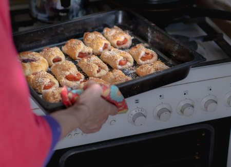 Sweet pastries on a baking sheet from the ovenの写真素材