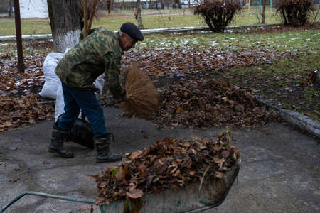 A man cleans and sweeps a yardの写真素材