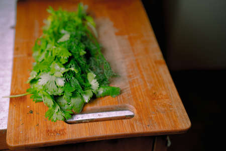 Greens lies on a cutting boardの写真素材