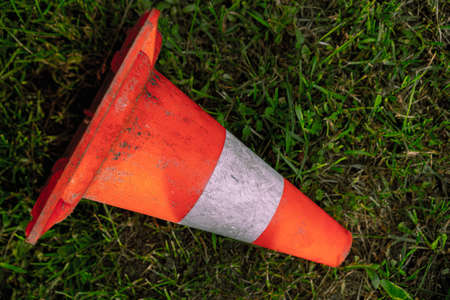 Warning road sign lies on the groundの写真素材