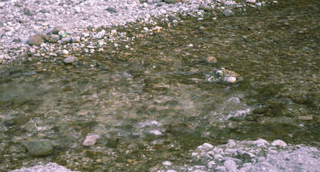 The flow of a mountain river over stones