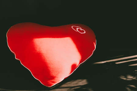 Heart-shaped pillow in the rays of the sunの写真素材