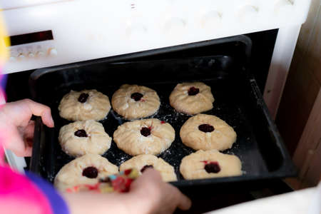 Buns with jam are placed in the oven