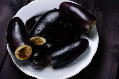 Cooking stuffed eggplant. Eggplant in a bowl of saltの写真素材