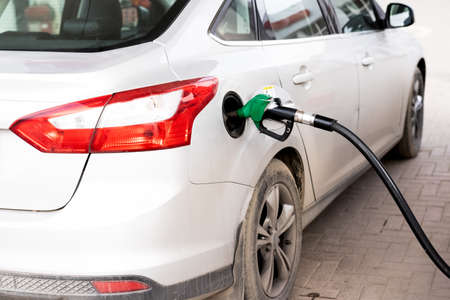 Refueling the car with gasoline at a gas stationの写真素材