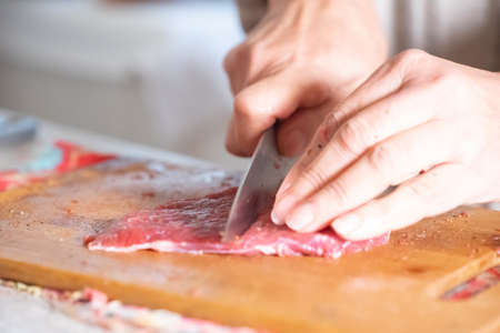 Cut a piece of meat with a knifeの写真素材