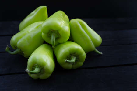 Sweet peppers on wooden backgroundの写真素材
