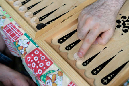 Camping, playing backgammon on the table