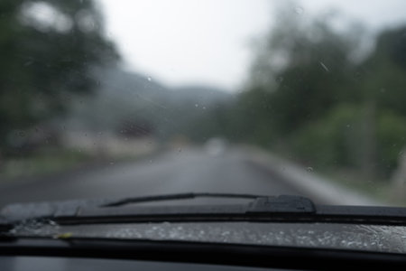 Old car driving in the rainの写真素材