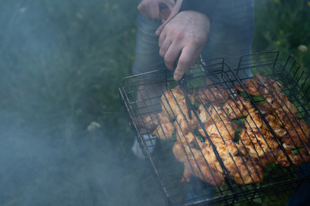 Pieces of meat are grilled on charcoalの写真素材