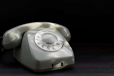 Rotary telephone on black backgroundの写真素材
