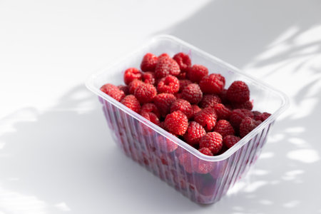 Ripe raspberries on a white background