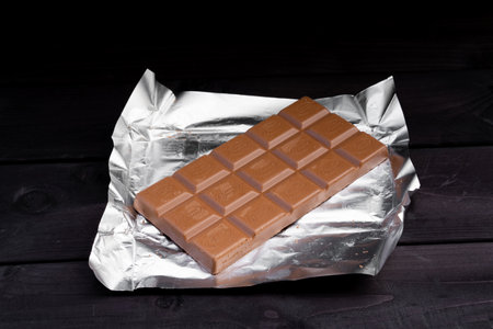 Bar of chocolate on wooden backgroundの写真素材