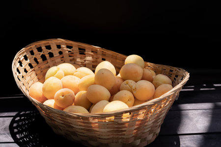Ripe apricots on wooden backgroundの写真素材