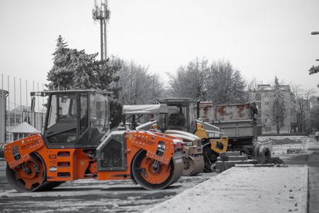 Heavy vehicles for road repairs stand in winterの写真素材