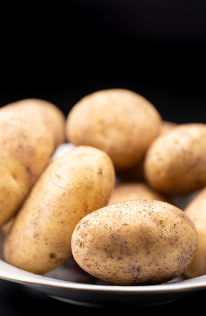Fresh potato lies on a plateの写真素材