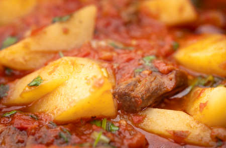 Meat dish with tomatoes and potatoesの写真素材