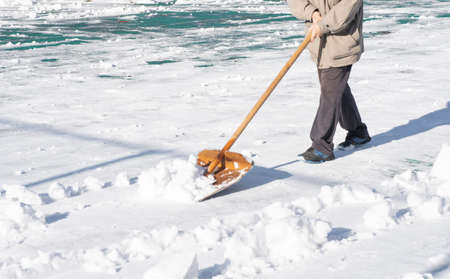 Snow removal with a snow shovelの写真素材
